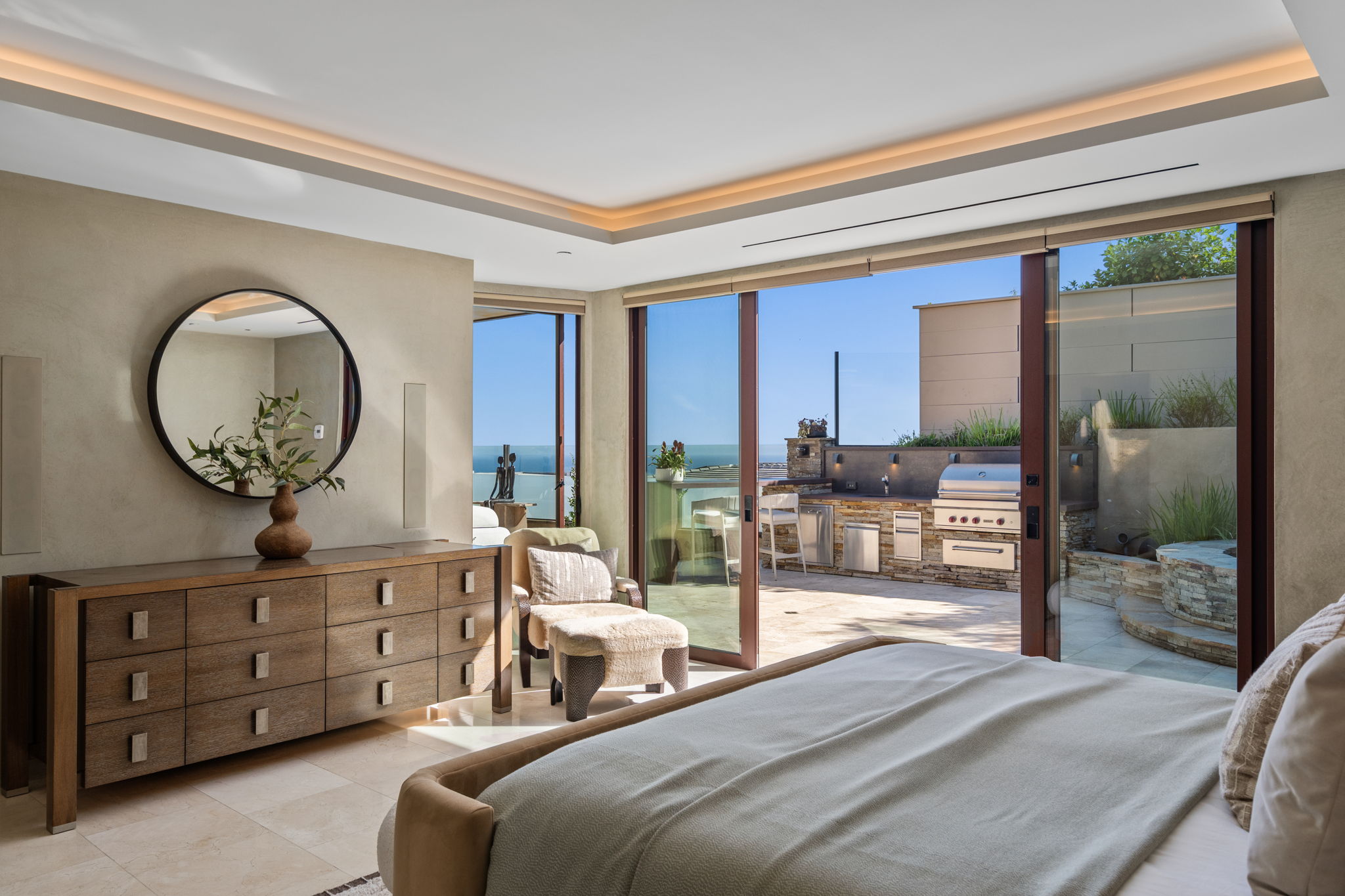 Primary suite with ocean view and patio access