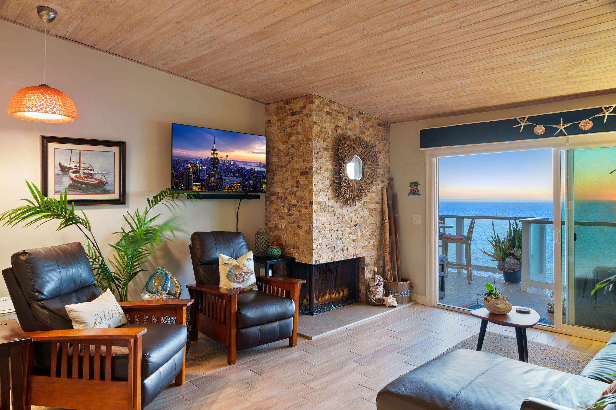 Luxury coastal living room featuring natural light and Pacific Ocean backdrop