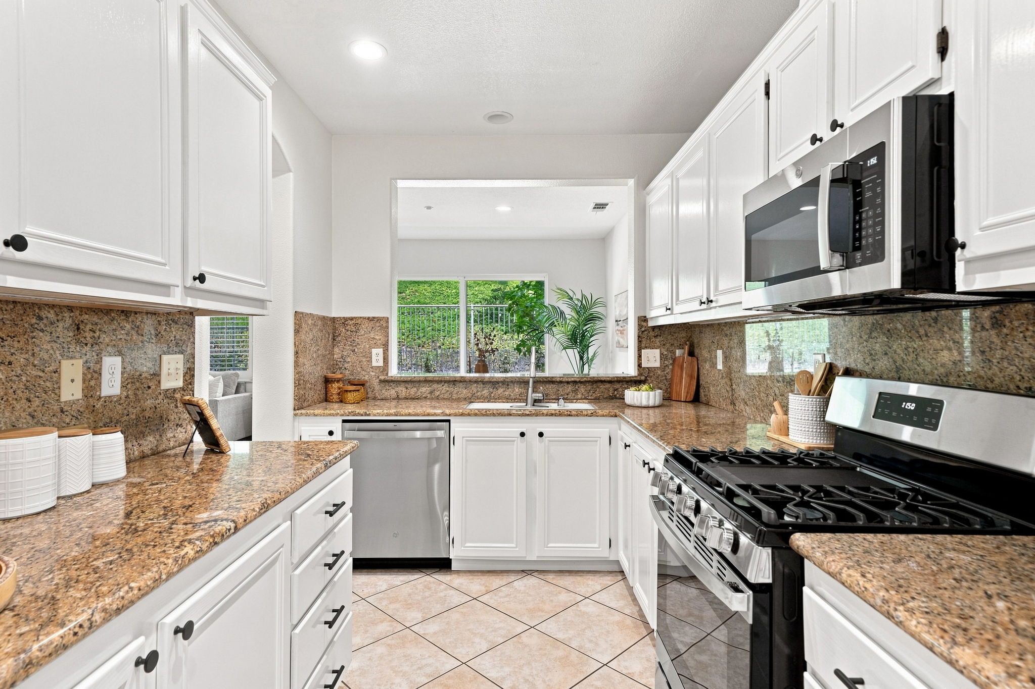 Kitchen with granite countertops and stainless appliances at 15 Calle Calurosa in San Clemente